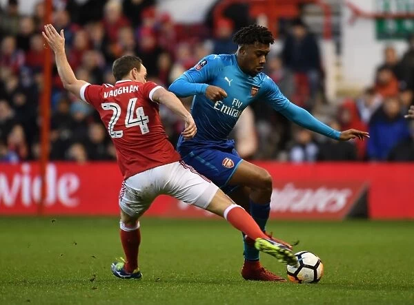 Arsenal's Alex Iwobi Outmaneuvers Nottingham Forest's David Vaughan in FA Cup Clash