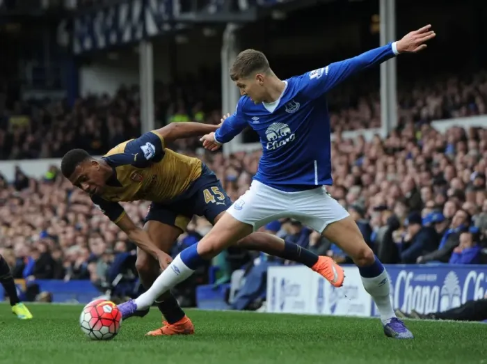 Framed Print : Arsenal's Alex Iwobi vs Everton's John Stones: Intense Face-Off in Premier League Showdown Framed Print : Arsenal's Alex Iwobi vs Everton's John Stones: Intense Face-Off in Premier League Showdown