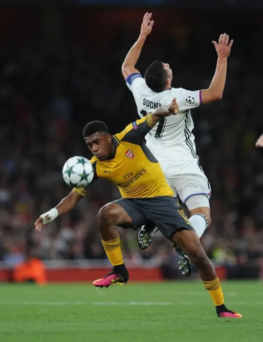 Framed Print : Arsenal's Alex Iwobi vs. FC Basel's Marek Suchy: A Champions League Showdown Framed Print : Arsenal's Alex Iwobi vs. FC Basel's Marek Suchy: A Champions League Showdown
