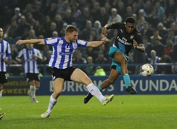 Arsenal's Alex Iwobi vs. Tom Lees: A Fierce Face-Off in the Capital One Cup Clash