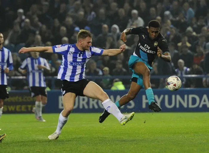 Framed Print : Arsenal's Alex Iwobi vs. Tom Lees: A Fierce Face-Off in the Capital One Cup Clash Framed Print : Arsenal's Alex Iwobi vs. Tom Lees: A Fierce Face-Off in the Capital One Cup Clash