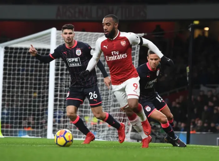 Framed Print : Arsenal's Alex Lacazette Clashes with Huddersfield's Schindler and Lowe Framed Print : Arsenal's Alex Lacazette Clashes with Huddersfield's Schindler and Lowe