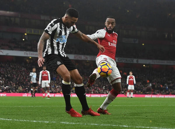 Arsenal's Alex Lacazette Clashes with Newcastle's Jamaal Lascelles in Premier League Showdown