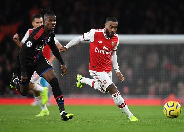 Arsenal's Alex Lacazette Outmaneuvers Crystal Palace's Wilfred Zaha in Premier League Clash