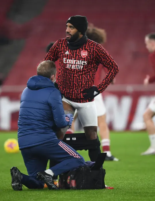 Framed Print : Arsenal's Alex Lacazette Receives Treatment from Physio Amidst Empty Emirates Stadium (Arsenal v Crystal Palace, 2021) Framed Print : Arsenal's Alex Lacazette Receives Treatment from Physio Amidst Empty Emirates Stadium (Arsenal v Crystal Palace, 2021)
