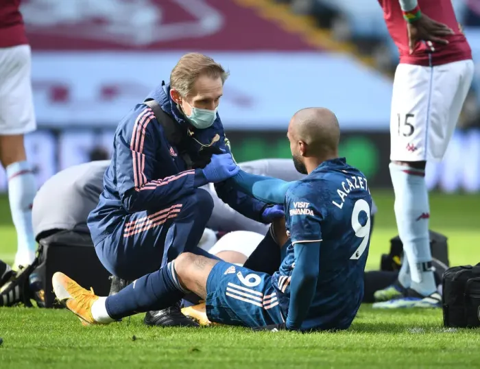 Framed Print : Arsenal's Alex Lacazette Receives Treatment from Physio during Aston Villa Match (Behind Closed Doors), 2021 Framed Print : Arsenal's Alex Lacazette Receives Treatment from Physio during Aston Villa Match (Behind Closed Doors), 2021