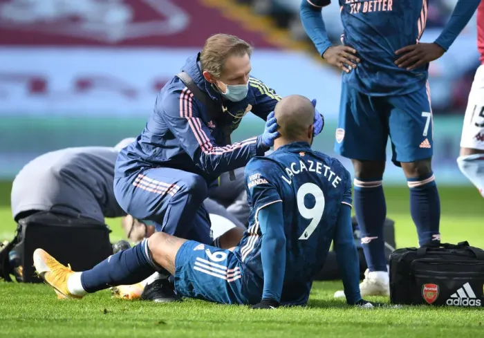 Framed Print : Arsenal's Alex Lacazette Receives Treatment from Physio during Aston Villa vs Arsenal (Behind Closed Doors) Framed Print : Arsenal's Alex Lacazette Receives Treatment from Physio during Aston Villa vs Arsenal (Behind Closed Doors)