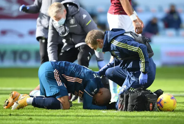 Framed Print : Arsenal's Alex Lacazette Receives Treatment from Physio in Empty Villa Park - Premier League 2020-21