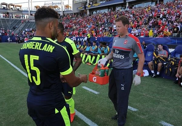 Arsenal's Alex Oxlade-Chamberlain Consults Team Physio Colin Lewin Before Arsenal v Chivas Match