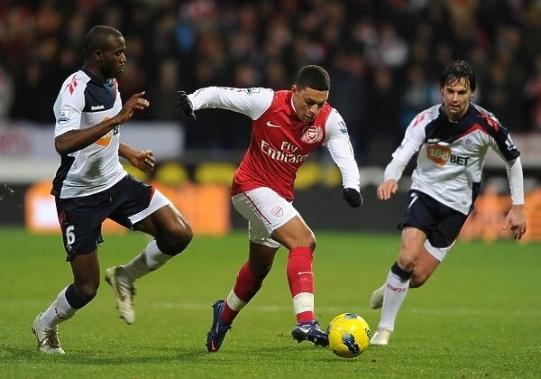 Arsenal's Alex Oxlade-Chamberlain Faces Off Against Bolton's Fabrice Muamba in Premier League Clash