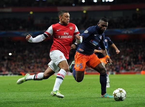 Arsenal's Alex Oxlade-Chamberlain Faces Off Against Montpellier's Henri Bedimo