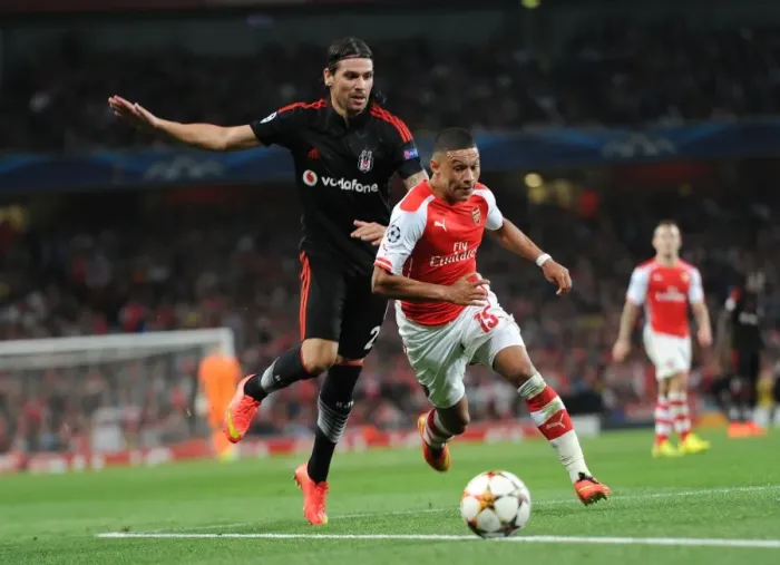 Framed Print : Arsenal's Alex Oxlade-Chamberlain Faces Off Against Besiktas Ersan Gulum in Champions League Clash Framed Print : Arsenal's Alex Oxlade-Chamberlain Faces Off Against Besiktas Ersan Gulum in Champions League Clash