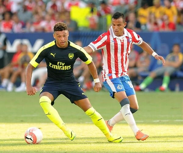 Arsenal's Alex Oxlade-Chamberlain Goes Head-to-Head with CD Guadalajara's Daniel Gonzalez