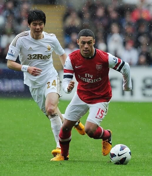 Arsenal's Alex Oxlade-Chamberlain Outmaneuvers Ki Sung-Yueng of Swansea