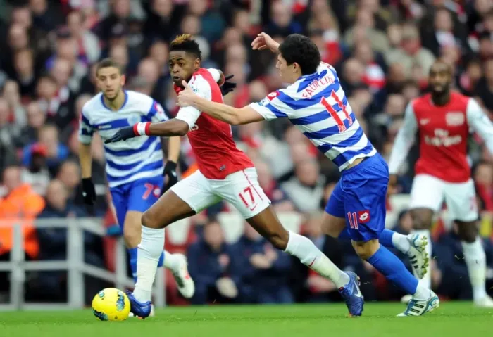Framed Print : Arsenal's Alex Song Clashes with QPR's Alejandro Faurlin during Premier League Match Framed Print : Arsenal's Alex Song Clashes with QPR's Alejandro Faurlin during Premier League Match