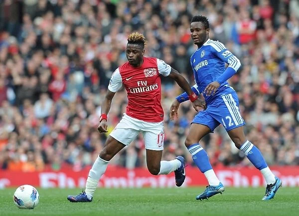 Arsenal's Alex Song Outmaneuvers Chelsea's John Obi Mikel