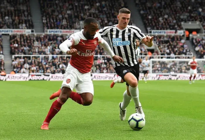 Framed Print : Arsenal's Alexandre Lacazette Faces Off Against Newcastle's Ciaran Clark in Premier League Clash