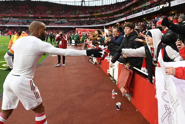 Arsenal's Alexandre Lacazette Greets Fan with Shirt after Arsenal v Newcastle United Match (2021-22)