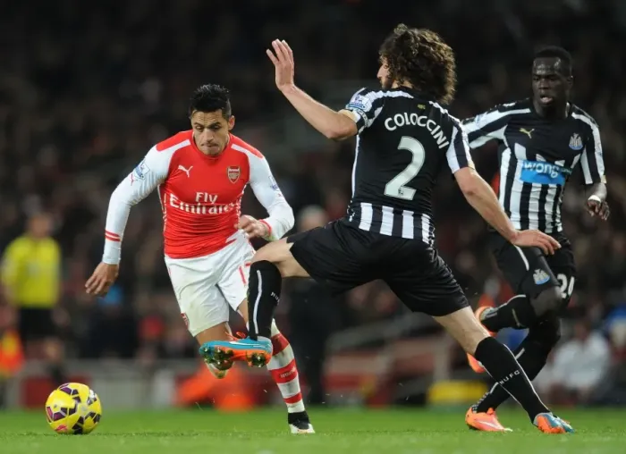 Framed Print : Arsenal's Alexis Sanchez Chases Down Newcastle's Fabricio Coloccini during the 2014 / 15 Premier League Match Framed Print : Arsenal's Alexis Sanchez Chases Down Newcastle's Fabricio Coloccini during the 2014 / 15 Premier League Match