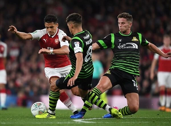 Arsenal's Alexis Sanchez Clashes with Doncaster's Defenders Jordan Houghton and Niall Mason in Carabao Cup Battle