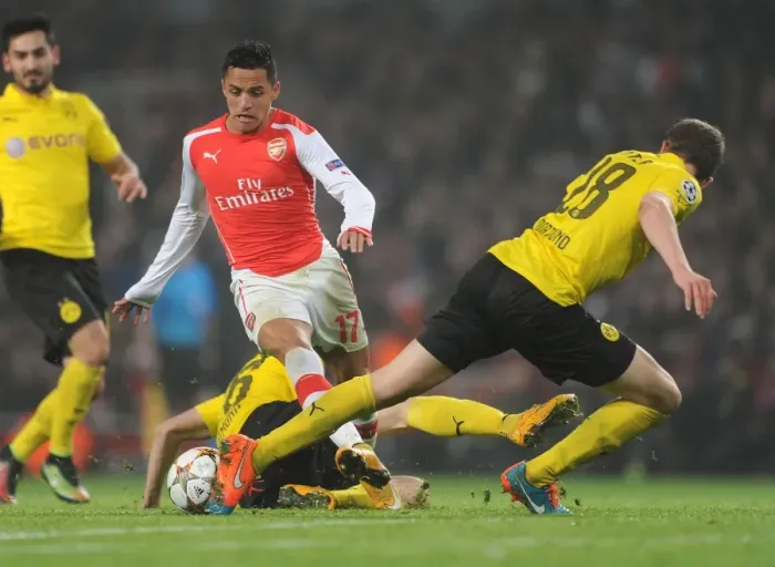 Framed Print : Arsenal's Alexis Sanchez Clashes with Dortmund's Piszczek and Ginter in Champions League Showdown Framed Print : Arsenal's Alexis Sanchez Clashes with Dortmund's Piszczek and Ginter in Champions League Showdown