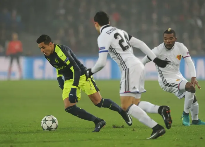 Framed Print : Arsenal's Alexis Sanchez Faces Off Against Basel's Mohamed Elyounoussi and Geoffroy Serey in 2016-17 UEFA Champions League Clash