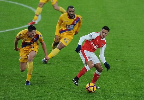 Arsenal's Alexis Sanchez Faces Off Against Crystal Palace's Martin Kelly and Jason Puncheon during the 2016-17 Premier League Match