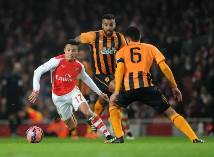 Framed Print : Arsenal's Alexis Sanchez Faces Off Against Hull City's Tom Huddlestone and Curtis Davies in FA Cup Clash Framed Print : Arsenal's Alexis Sanchez Faces Off Against Hull City's Tom Huddlestone and Curtis Davies in FA Cup Clash
