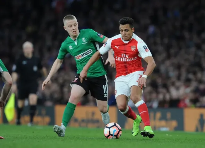 Framed Print : Arsenal's Alexis Sanchez Faces Off Against Lincoln's Terry Hawkridge in FA Cup Quarter-Final Showdown Framed Print : Arsenal's Alexis Sanchez Faces Off Against Lincoln's Terry Hawkridge in FA Cup Quarter-Final Showdown