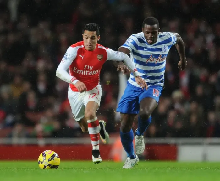 Framed Print : Arsenal's Alexis Sanchez Faces Off Against Nedum Onuoha in Premier League Clash (Arsenal v Queens Park Rangers 2014-15)