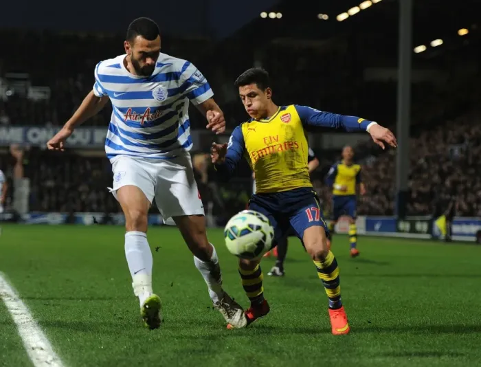 Framed Print : Arsenal's Alexis Sanchez Faces Off Against QPR's Steve Caulker in Premier League Clash Framed Print : Arsenal's Alexis Sanchez Faces Off Against QPR's Steve Caulker in Premier League Clash