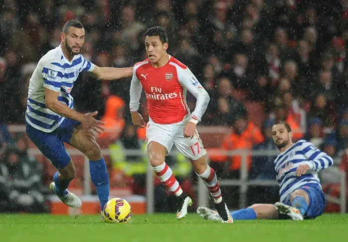 Framed Print : Arsenal's Alexis Sanchez Faces Off Against QPR's Steven Caulker and Niko Kranjcar