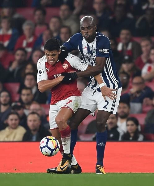 Arsenal's Alexis Sanchez Fends Off Allan Nyom in Premier League Clash