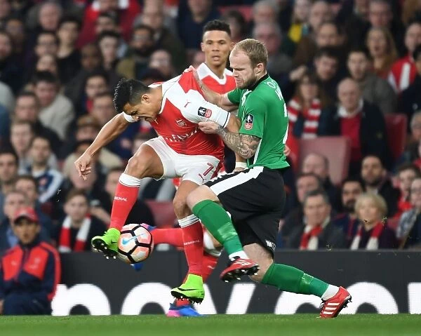 Arsenal's Alexis Sanchez Fends Off Lincoln's Bradley Wood in FA Cup Quarter-Final Clash