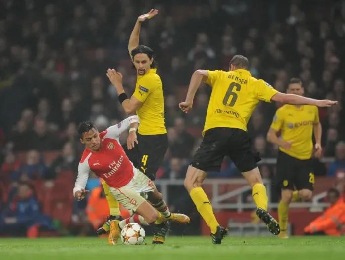 Framed Print : Arsenal's Alexis Sanchez Fouls by Dortmund's Subotic and Bender in 2014-15 Champions League Clash Framed Print : Arsenal's Alexis Sanchez Fouls by Dortmund's Subotic and Bender in 2014-15 Champions League Clash