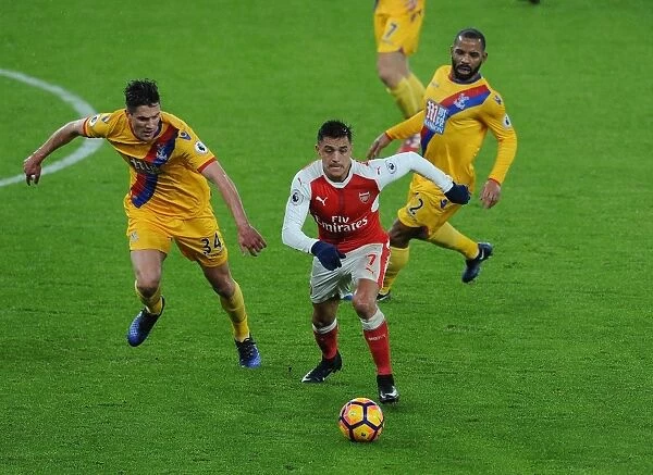 Arsenal's Alexis Sanchez Goes Head-to-Head with Martin Kelly and Jason Puncheon of Crystal Palace