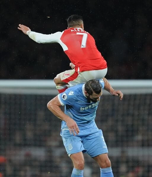Arsenal's Alexis Sanchez Leaps Above Stoke's Erik Pieters in Premier League Clash