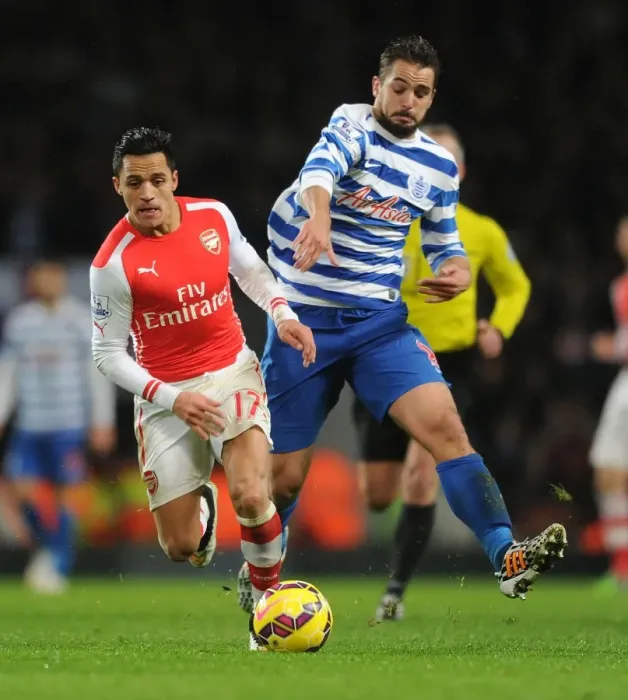 Framed Print : Arsenal's Alexis Sanchez Outmaneuvers QPR's Nico Kranjcar during the 2014-15 Premier League Match Framed Print : Arsenal's Alexis Sanchez Outmaneuvers QPR's Nico Kranjcar during the 2014-15 Premier League Match