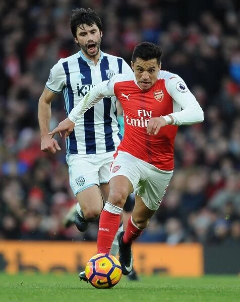 Arsenal's Alexis Sanchez Outmaneuvers West Brom's Claudio Yacob in Premier League Clash