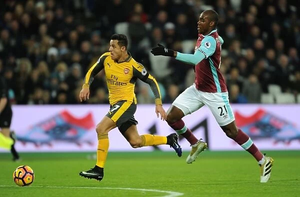 Arsenal's Alexis Sanchez Outmaneuvers West Ham's Angelo Ogbonna in Premier League Clash