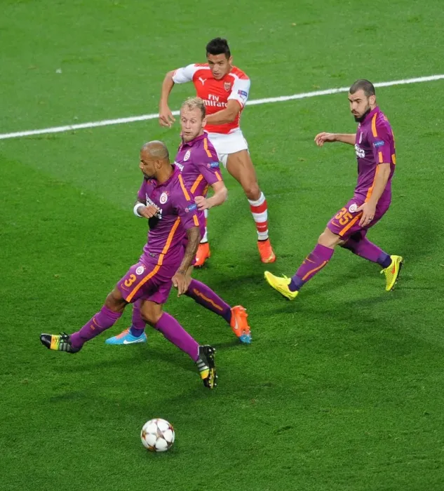 Framed Print : Arsenal's Alexis Sanchez Takes On Galatasaray's Defense in 2014 Champions League Clash Framed Print : Arsenal's Alexis Sanchez Takes On Galatasaray's Defense in 2014 Champions League Clash