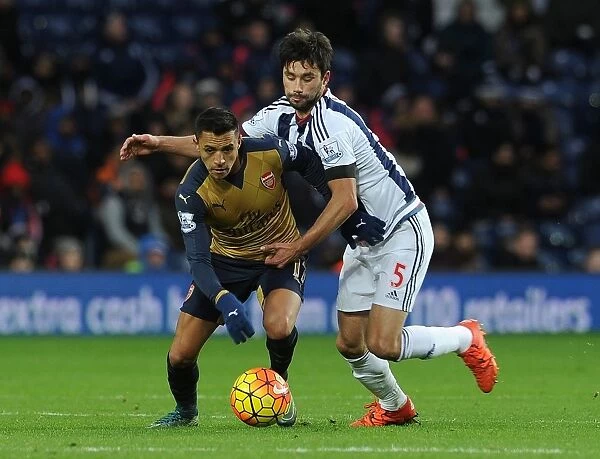 Arsenal's Alexis Sanchez vs. Claudio Yacob: A Fierce Battle in the Premier League Clash between West Brom and Arsenal (November 2015)