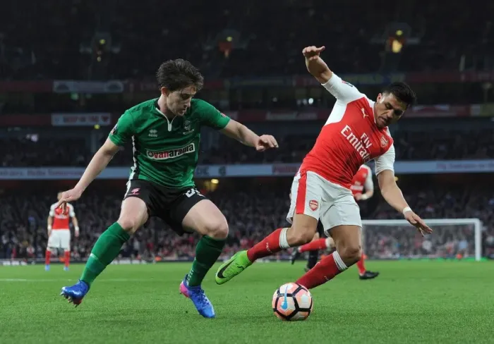 Framed Print : Arsenal's Alexis Sanchez vs. Lincoln City's Alex Woodyard: A FA Cup Quarter-Final Battle Framed Print : Arsenal's Alexis Sanchez vs. Lincoln City's Alex Woodyard: A FA Cup Quarter-Final Battle