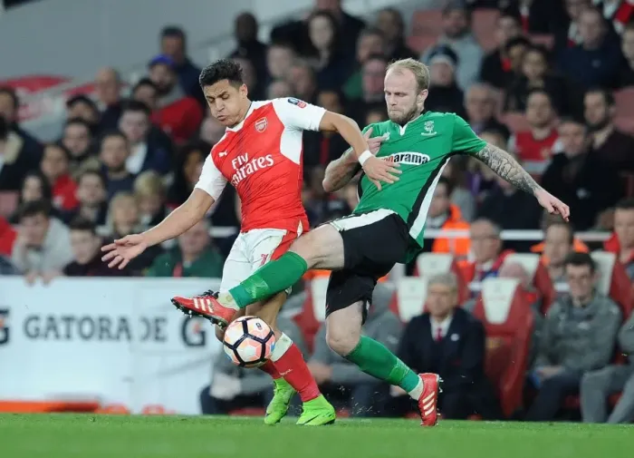Framed Print : Arsenal's Alexis Sanchez vs. Lincoln's Bradley Wood: A FA Cup Quarter-Final Battle