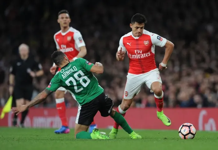 Framed Print : Arsenal's Alexis Sanchez vs. Nathan Arnold: A FA Cup Quarter-Final Showdown Framed Print : Arsenal's Alexis Sanchez vs. Nathan Arnold: A FA Cup Quarter-Final Showdown