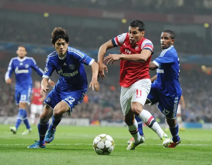 Framed Print : Arsenal's Andre Santos Goes Head-to-Head with Atsuto Uchida and Jefferson Farfan of Schalke in Champions League Showdown Framed Print : Arsenal's Andre Santos Goes Head-to-Head with Atsuto Uchida and Jefferson Farfan of Schalke in Champions League Showdown