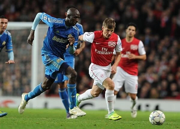 Arsenal's Andrey Arshavin Breaks Past Marseille's Alou Diarra in 2011-12 Champions League Clash