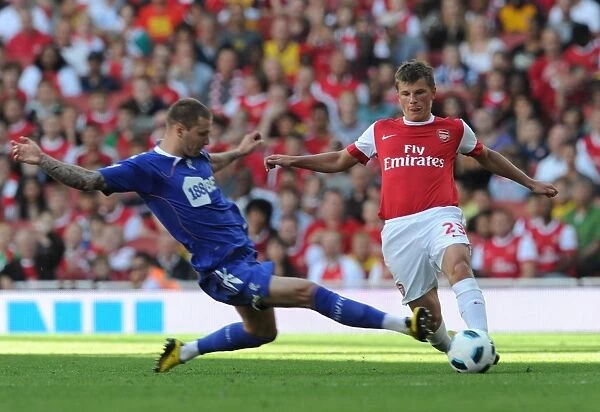 Arsenal's Andrey Arshavin Scores against Bolton's Gretar Steinsson in Arsenal's 4-1 Victory over Blackburn Rovers