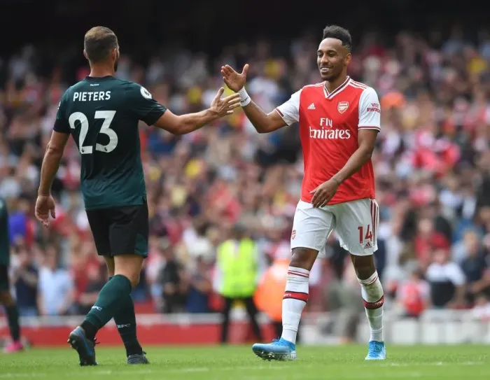 Framed Print : Arsenal's Aubameyang Celebrates with Burnley's Pieters after Intense Arsenal v Burnley Clash (2019-20)