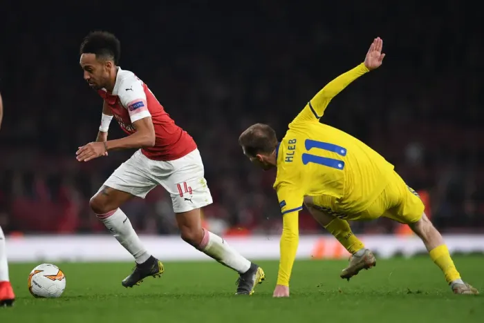 Framed Print : Arsenal's Aubameyang Clashes with BATE's Hleb in Europa League Showdown Framed Print : Arsenal's Aubameyang Clashes with BATE's Hleb in Europa League Showdown